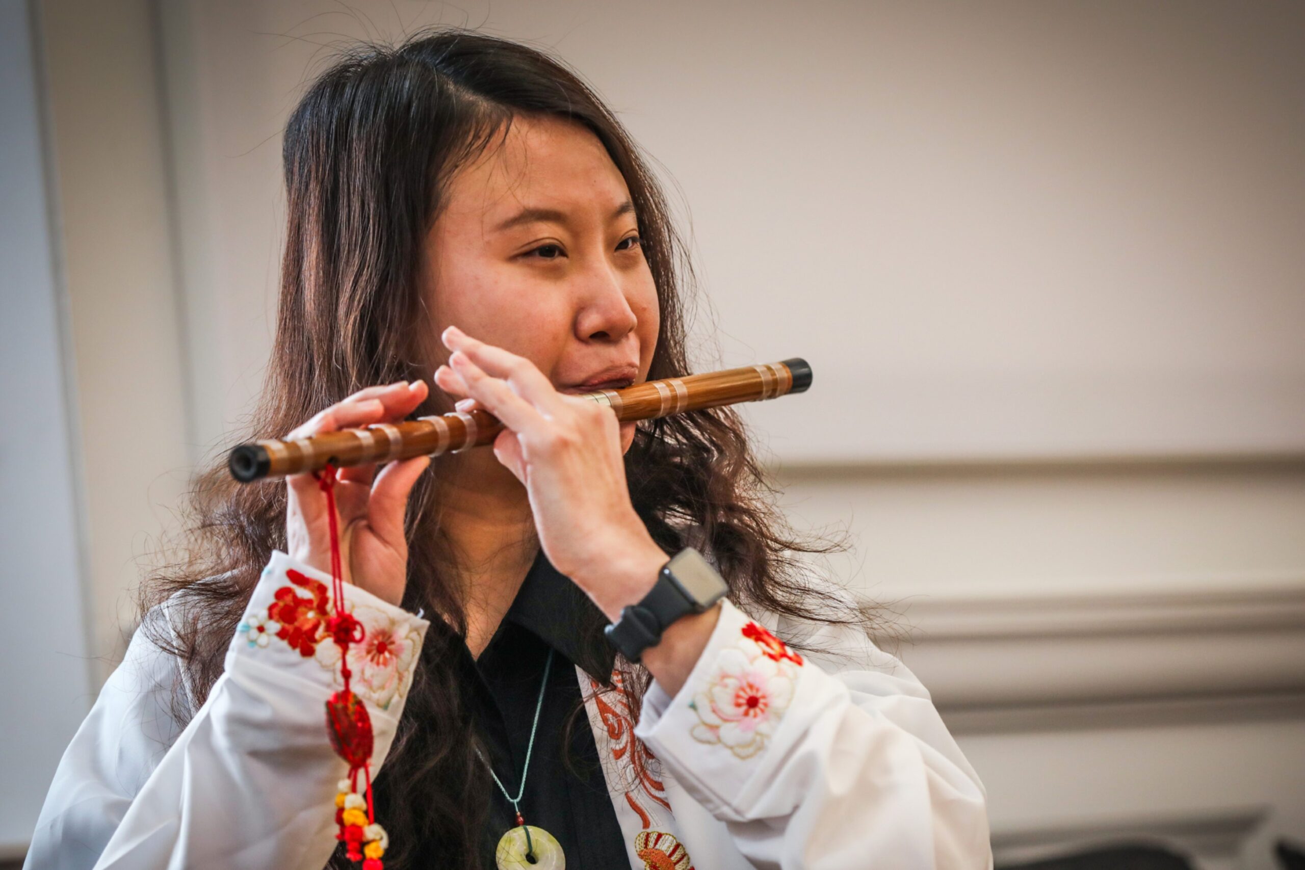 A woman plays an instrument. 