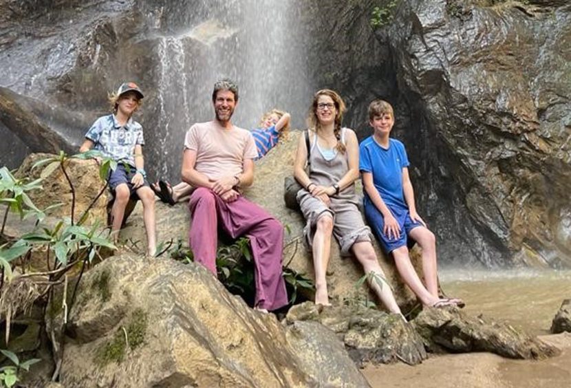 James, Jasmine and sons in front of a waterfall in Myanmar. 