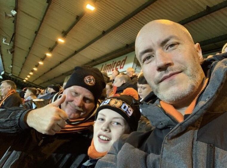 Paul McNicoll (right) with his family at a football match in Dundee.