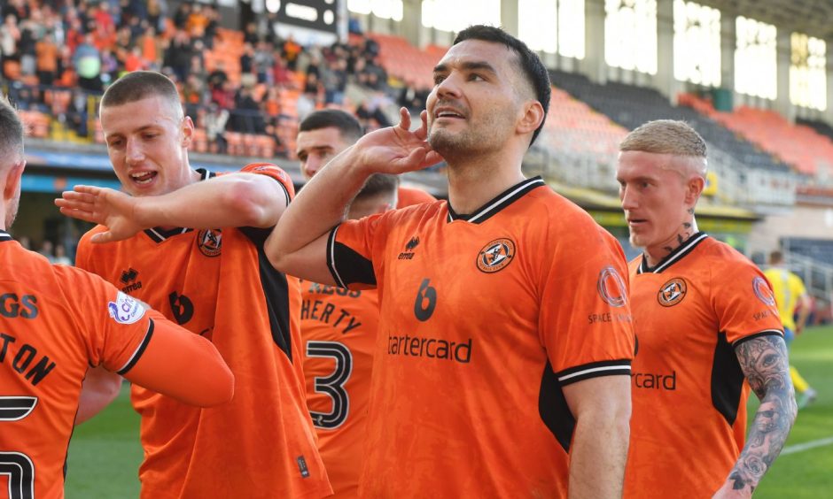 Tony Watt laps up the win for Dundee United as he cups his ear looking for acclaim from supporters.