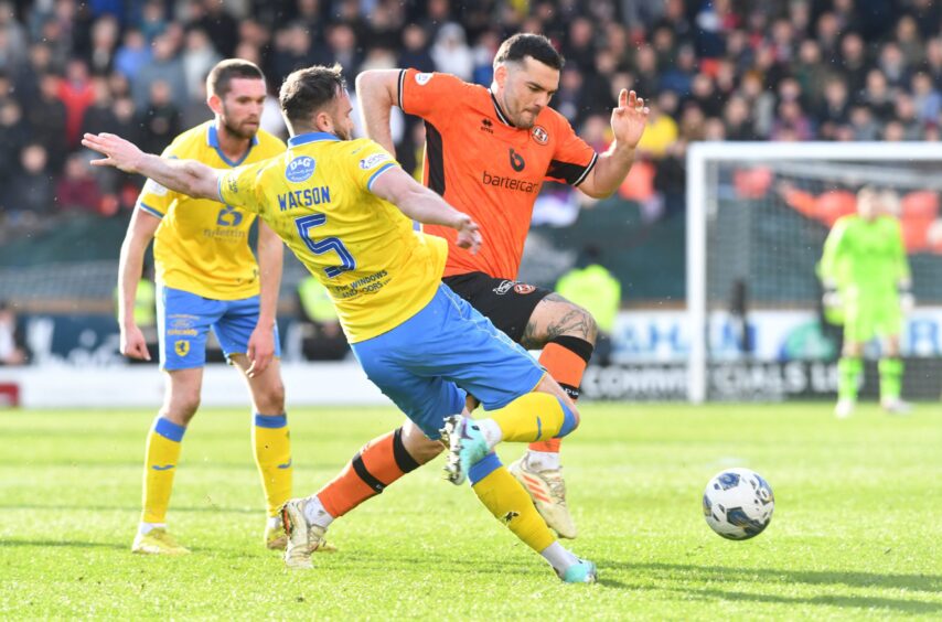 Tony Watt in full flow for Dundee United as Keith Watson prepares to tackle him.