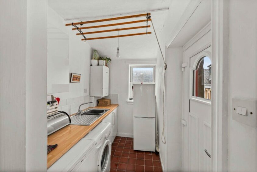 A utility room sits off the kitchen. 