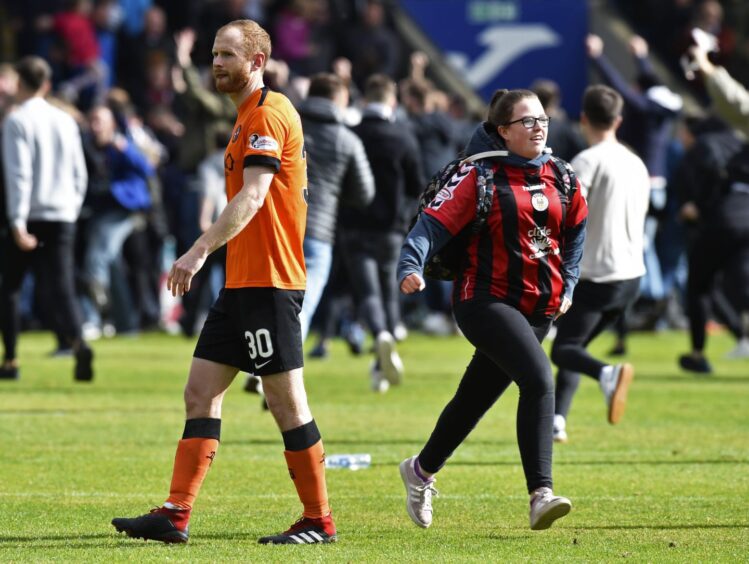A gutted Mark Reynolds as delighted St Mirren fans invade the pitch following their playoff survival.