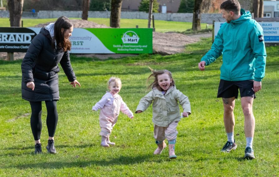 Phoebe and Freya Findlay running with Mum and Dad at Forfar Parkrun.