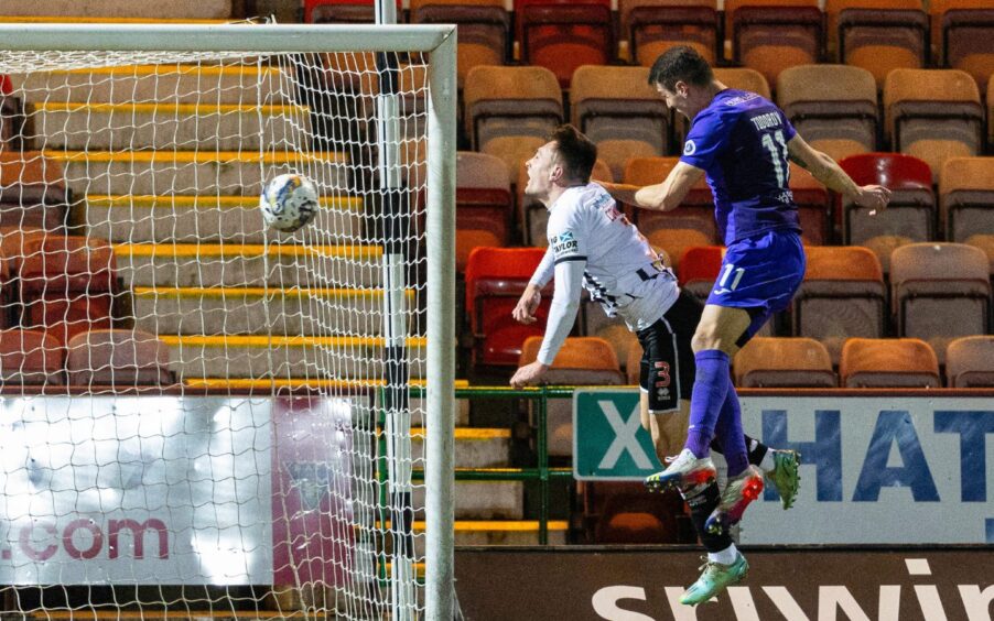 Nikolay Todorov rises above Dunfermline Athletic F.C. defender Josh Edwards to head in a goal for Airdrie.