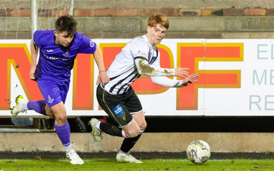 Dunfermline Athletic F.C. midfielder Ben Summers takes on Airdrie's Charlie Telfer with the ball at his feet.