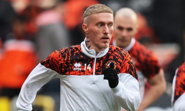 Dundee United star Craig Sibbald warms up.