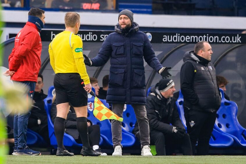 Dunfermline Athletic F.C. manager James McPake questions the assistant-referee as Raith Rovers counterpart Ian Murray looks on.