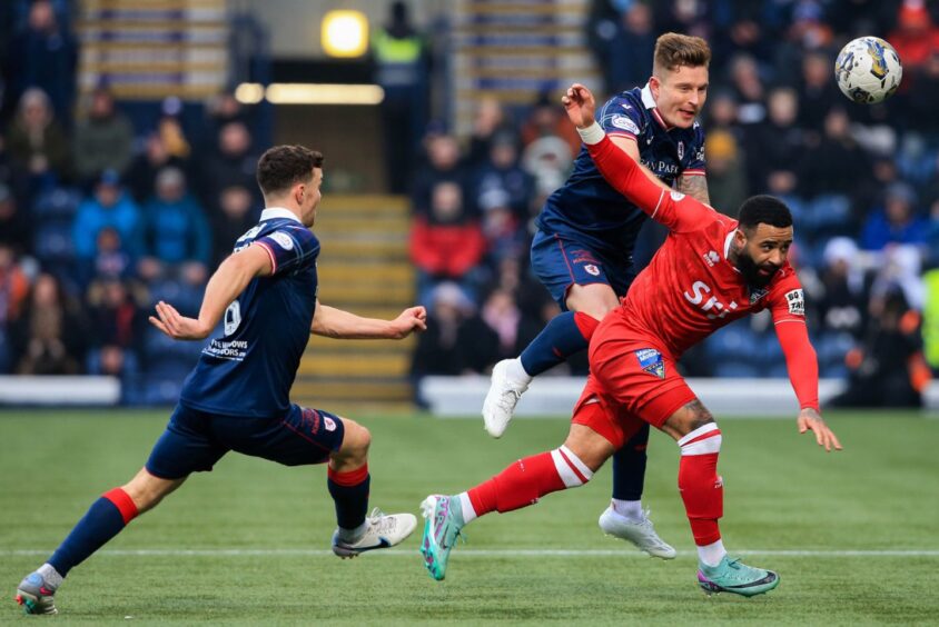 With team-mate Ross Matthews close by in support, Raith Rovers defender Euan Murray climbs above Dunfermline striker Alex Jakubiak to win the ball.