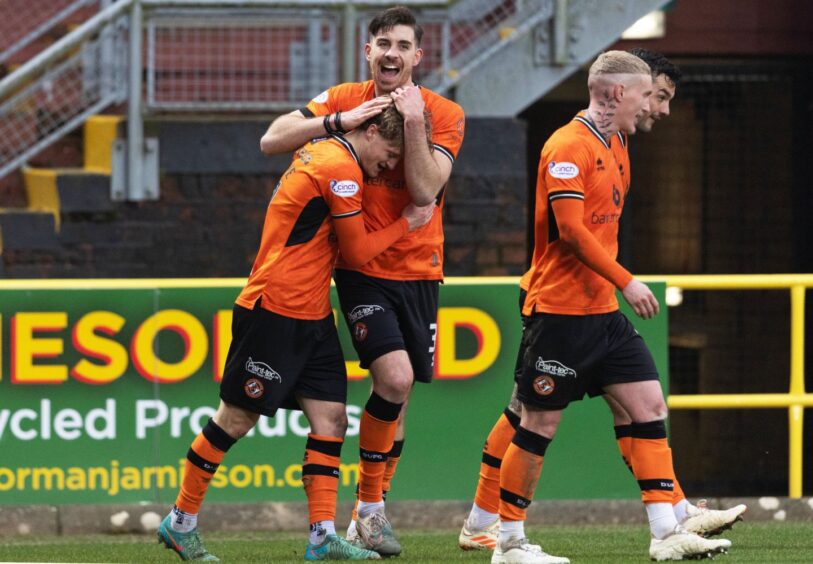 Alex Greive, left, is congratulated by Declan Gallagher after scoring