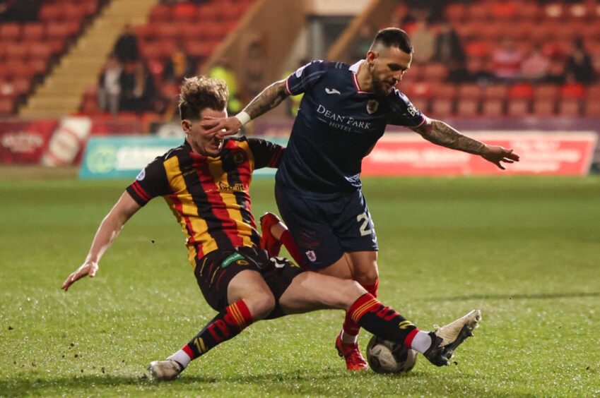 Raith Rovers attacker Dylan Easton is thwarted by Partick Thistle midfielder Luke McBeth.