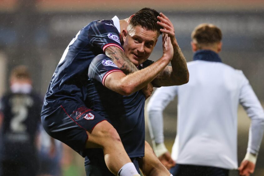 Dylan Easton climbs on the back of Raith Rovers match-winner Euan Murray following victory over Partick Thistle.