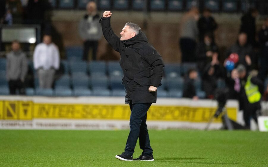 Tony Docherty salutes Dundee fans in the South Enclosure after his side's midweek win over Aberdeen.