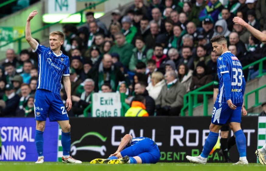 The St Johnstone players call for Sven Sprangler to receive treatment for his knee injury. 