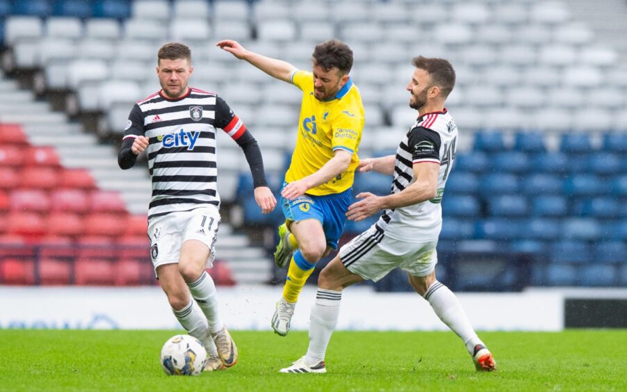 Raith Rovers' Aidan Connolly has the ball but is challenged by Queen's Park midfielder Sean Welsh as Dom Thomas looks on.