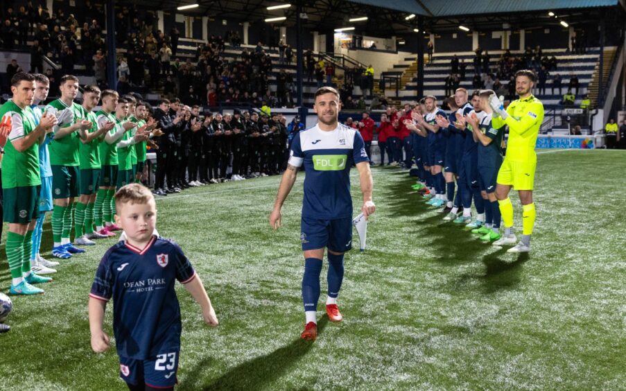 Lewis Vaughan is clapped onto the Stark's Park pitch for his testimonial match by a guard of honour of players from Raith Rovers and Hibernian.