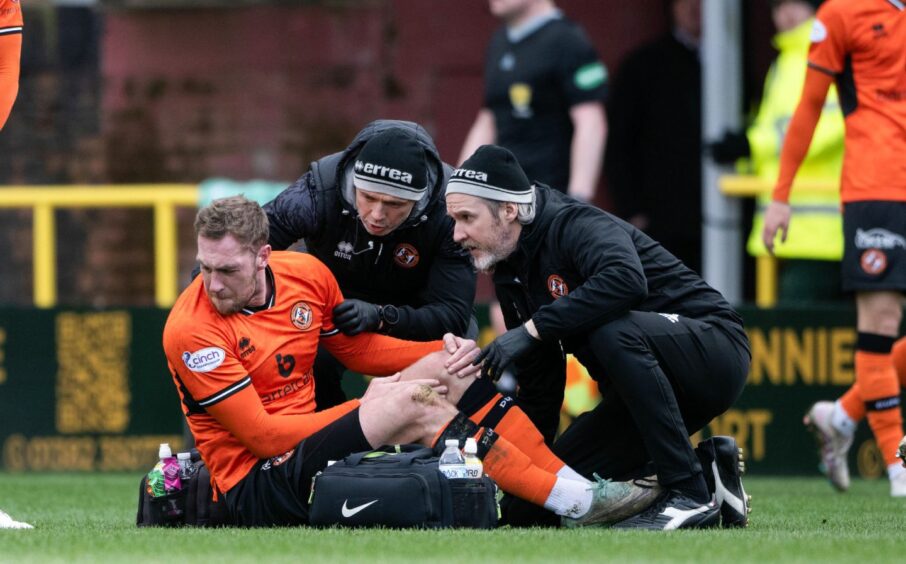 Kevin Holt of Dundee United nurses an injury