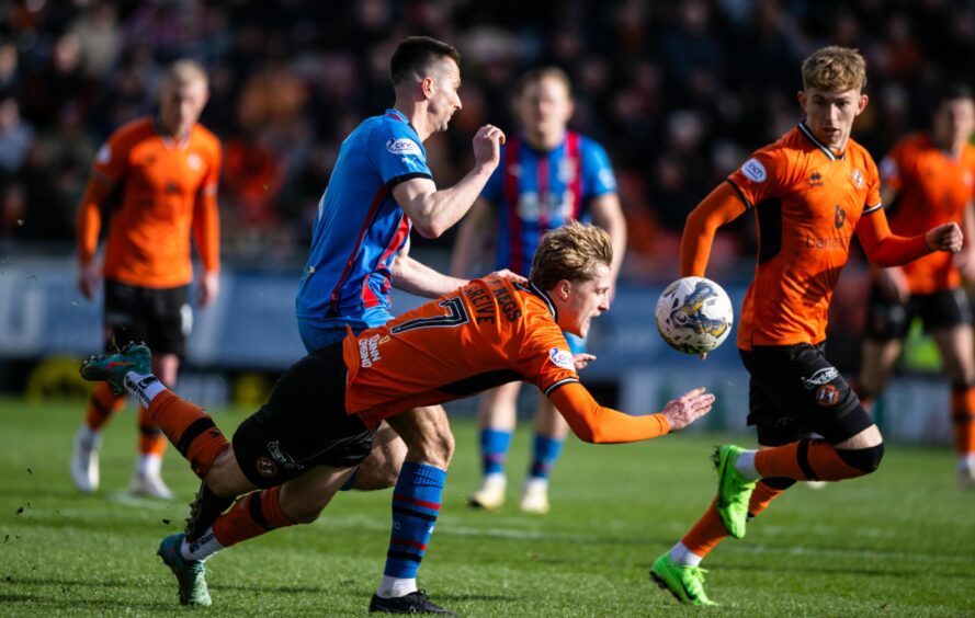 Dundee United's Alex Greive is knocked off the ball