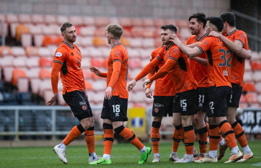 Louis Moult, left, takes the acclaim of his teammates