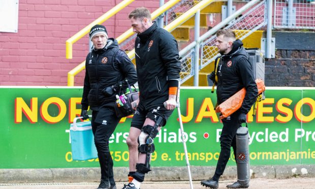 Kevin Holt of Dundee United on crutches