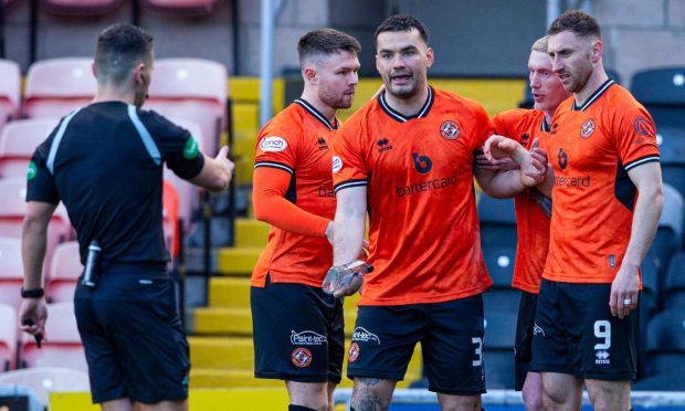 Tony Watt picks up a glass bottle after celebrating Dundee United's opening goal against Raith Rovers.