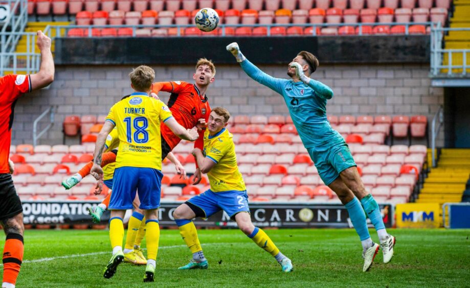 A flying Kevin Dabrowski punches a cross to safety