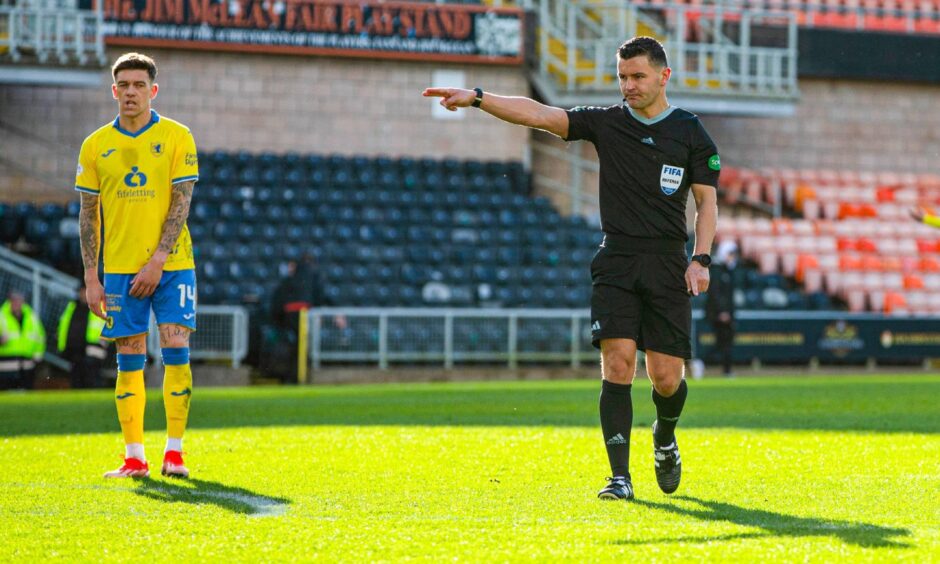 Referee Nick Walsh points to the penalty spot