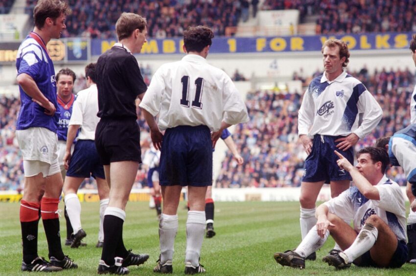 Jimmy Nicholl looks on as McStay makes his point to Kenny Clark.