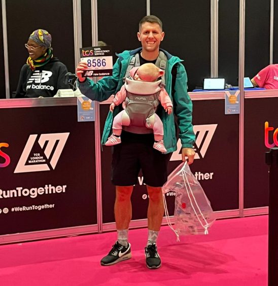Andrew Findlay, from Forfar, with Freya in her baby carrier after London Marathon.