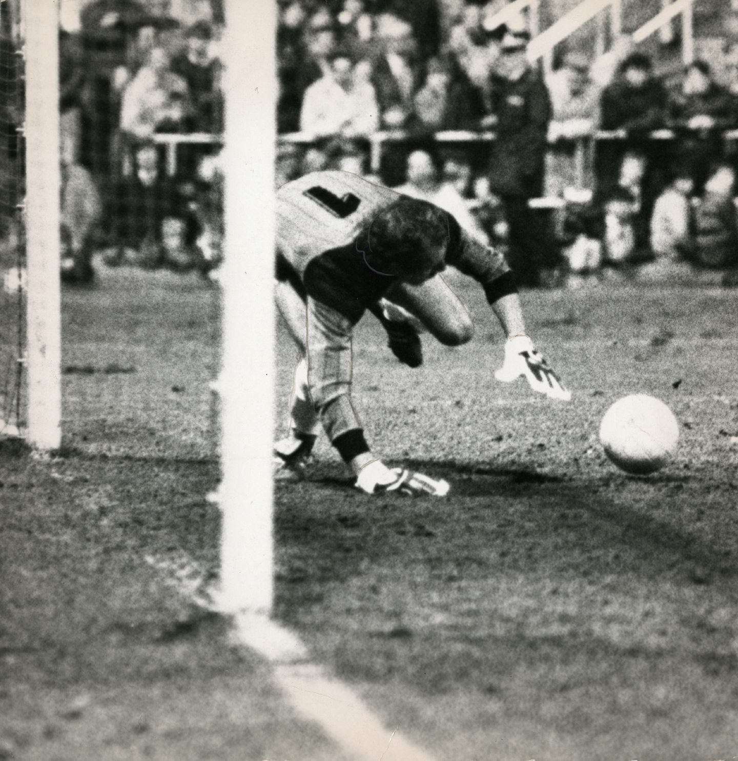 Herbert Feurer stoops to gather in a ball in the Austrians' goalmouth