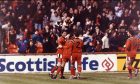 The players celebrate Andy McLaren's opening goal in front of the Dundee United fans