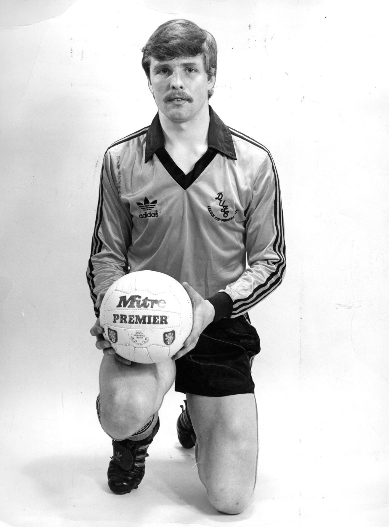 Derek Stark in his Tangerines kit and holding a football