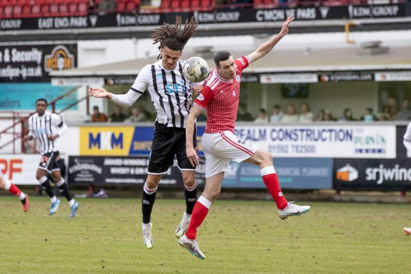 Miles Welch-Hayes wins an aerial challenge for Dunfermline Athletic F.C.