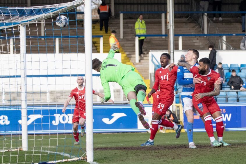 Miles Welch-Hayes' looping header lands over Morton goalkeeper Ryan Mullen to give Dunfermline the lead.