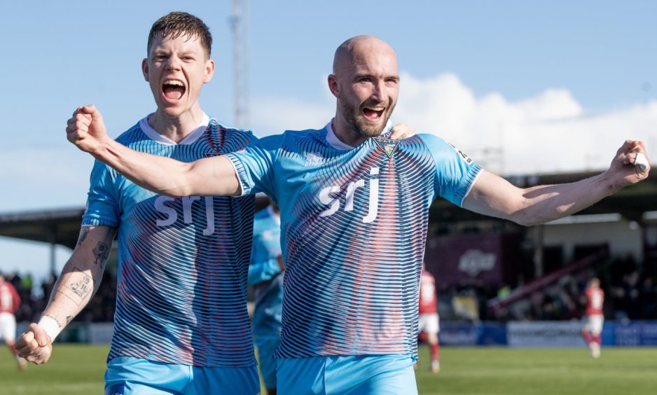 Arms outstretched, Chris Kane celebrates scoring his second goal for Dunfermline Athletic F.C. as he is joined by Sam Fisher.