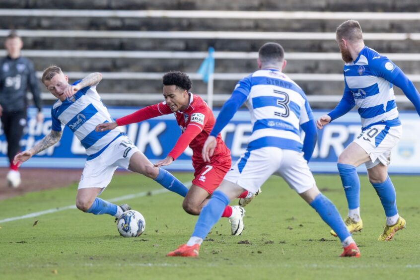 Dunfermline winger Kane Ritchie-Hosler is fouled as he is surrounded by three Morton opponents.