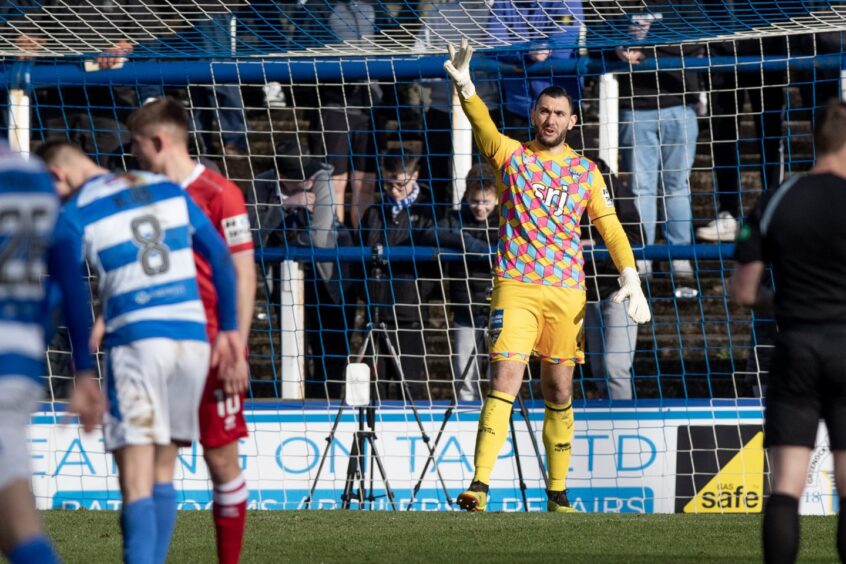 Deniz Mehmet holds up three fingers to celebrate his hat-trick of penalty saves for Dunfermline Athletic F.C.