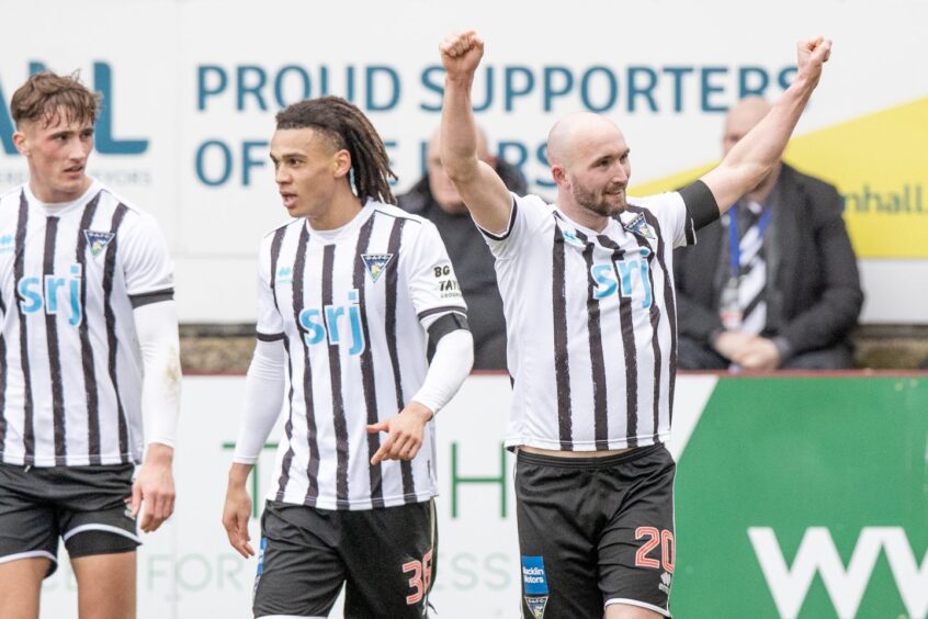 Chris Kane raises both arms in the air as he celebrates scoring his first goal for Dunfermline.