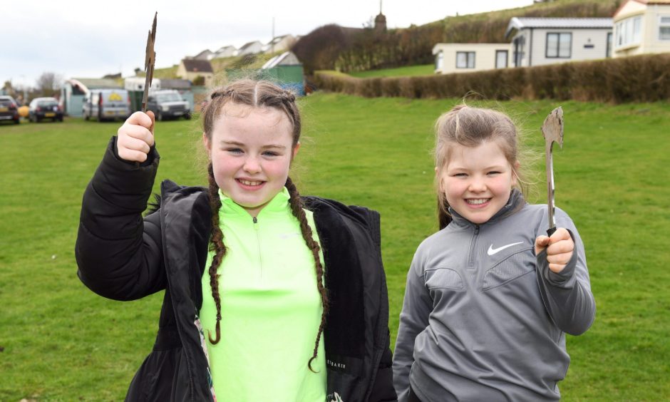 Eleven-year-olds Sophia and Ava have a go at axe throwing.