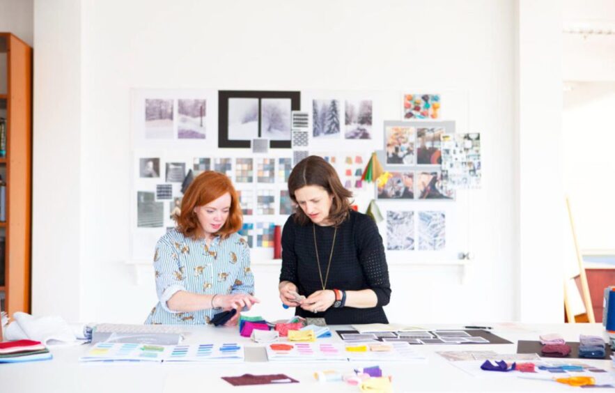 two women work with colourful textile samples as Todd and Duncan offer apprenticeships in Scotland