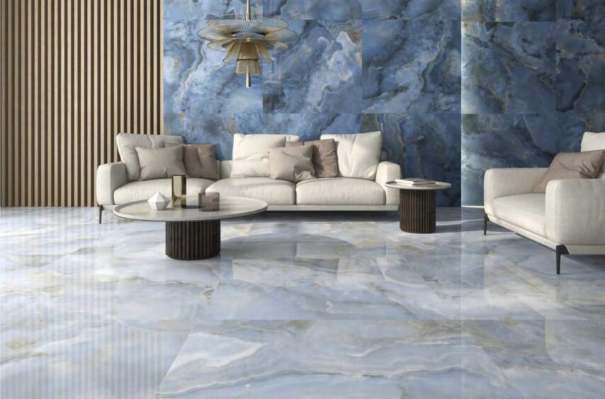 a modern tiled living room with statement blue marble wall and classic marble flooring