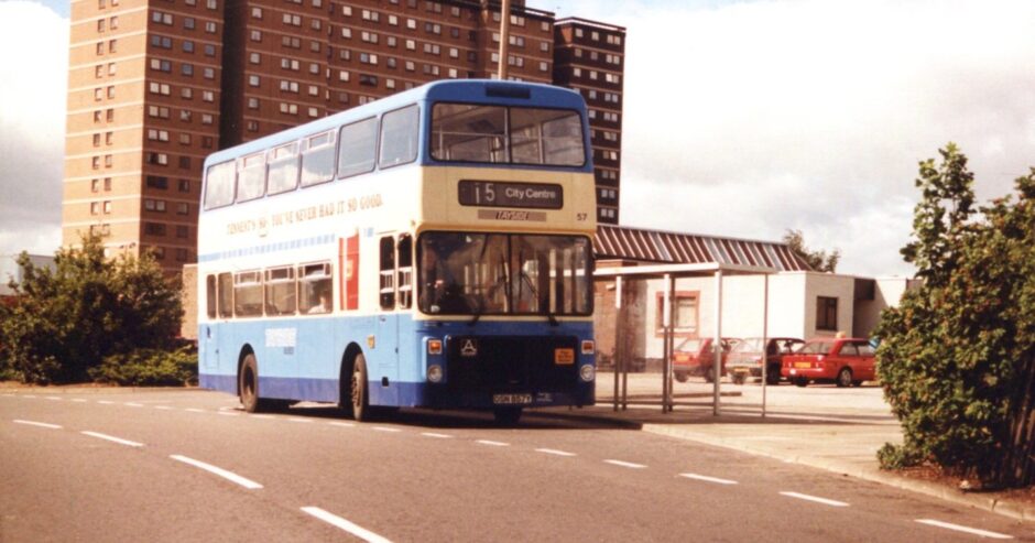 Bus 57 on its way to Dundee city centre with the Whitfield multis still standing. 