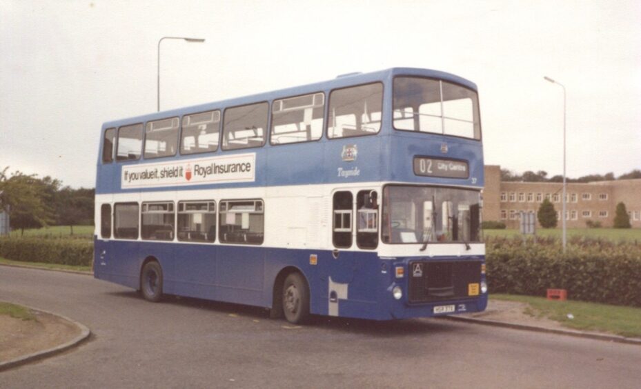 A blue double decker bus sits in Linton Road in Dryburgh, where the terminus for services 2-4 was in the 1980s.
