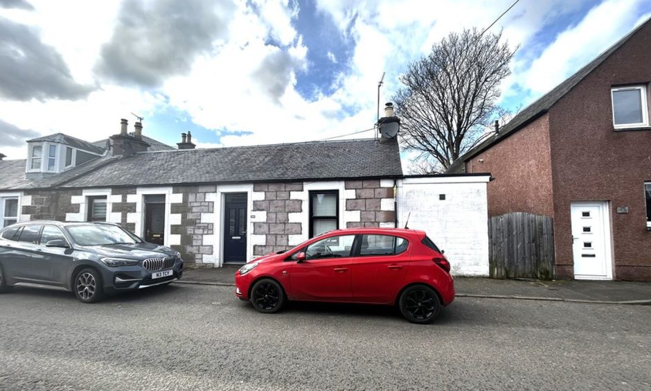 Cars parked on the street outside the cottage in Blairgowrie