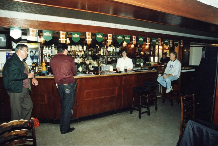 Regulars sit at the bar and enjoy a drink at the King Street pub.