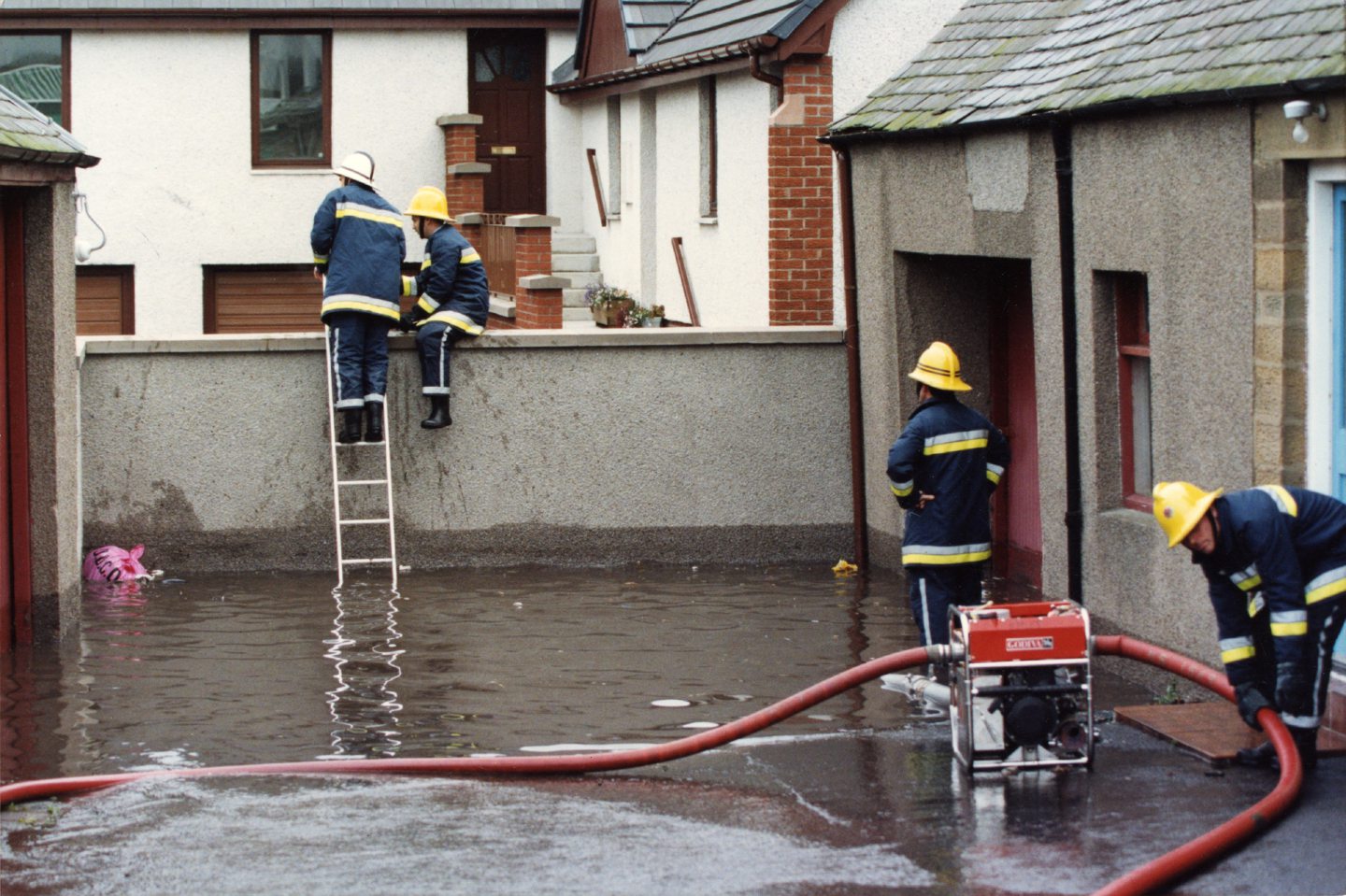Firefighters standing in a large pool of water in Ferry Road