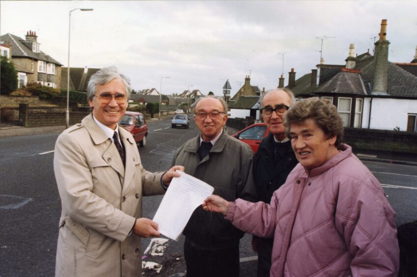Andrew Welsh receives the petition from three locals in December 1993. 