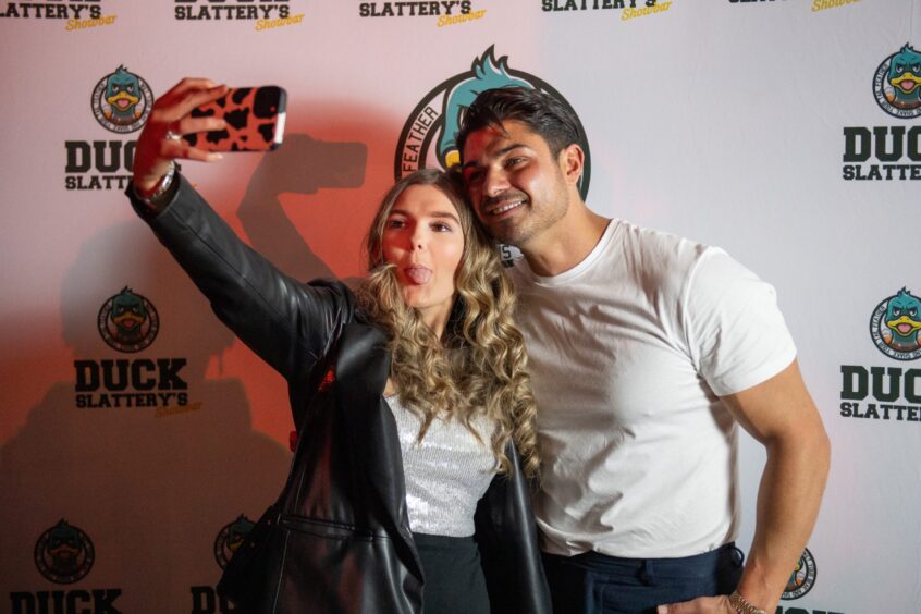 A fan sticks her tongue out for a photo with Anton Danyluk in Dundee.