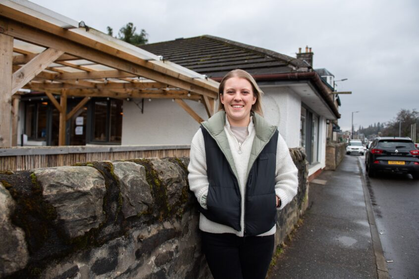 Smiling Daisy Walker outside Jessie's Cafe on Atholl Road, Pitlochry