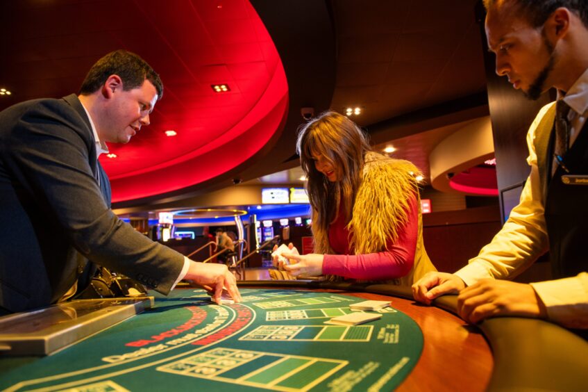 Ross and Jordon teach Rebecca how to shuffle the cards like a pro at Grosvenor Casino. 